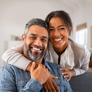 Happy couple smiling with bright, white teeth
